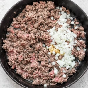 Ground beef and onions cooked in a skillet with flavorful slow cooker chili spices.