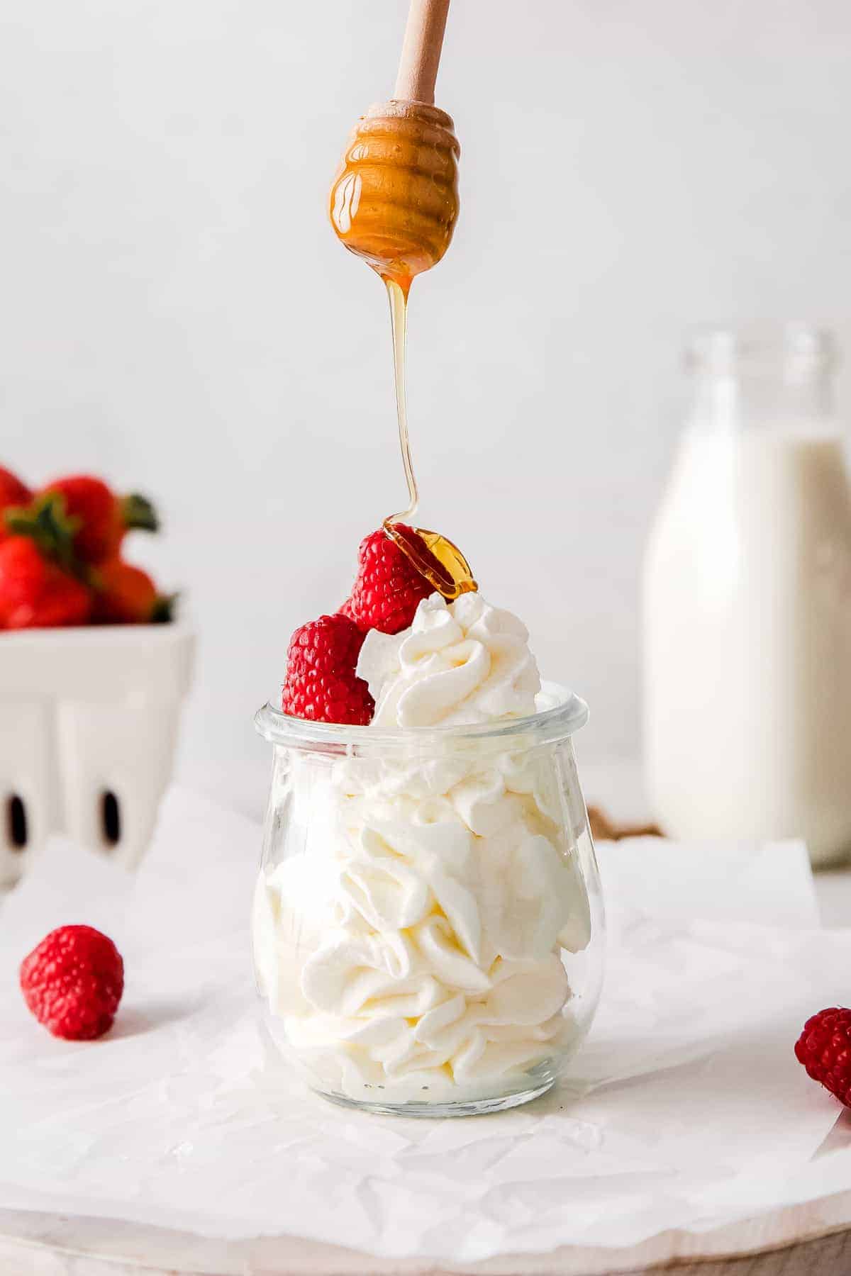 Drizzling honey over homemade whipped cream.