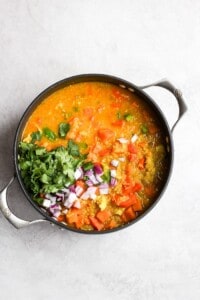 a bowl of indian vegetable stew on a white background.