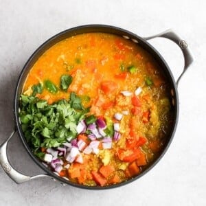 a bowl of indian vegetable stew on a white background.