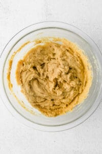 peanut butter in a bowl on a white background.