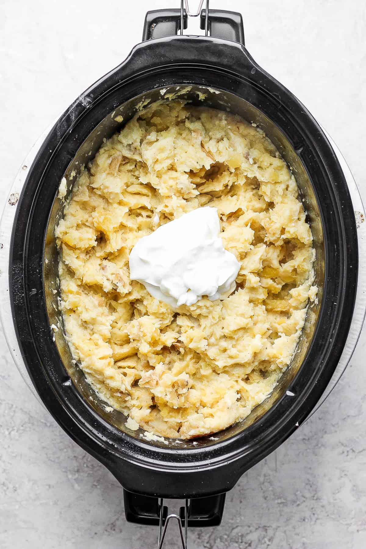 adding butter to mashed potatoes