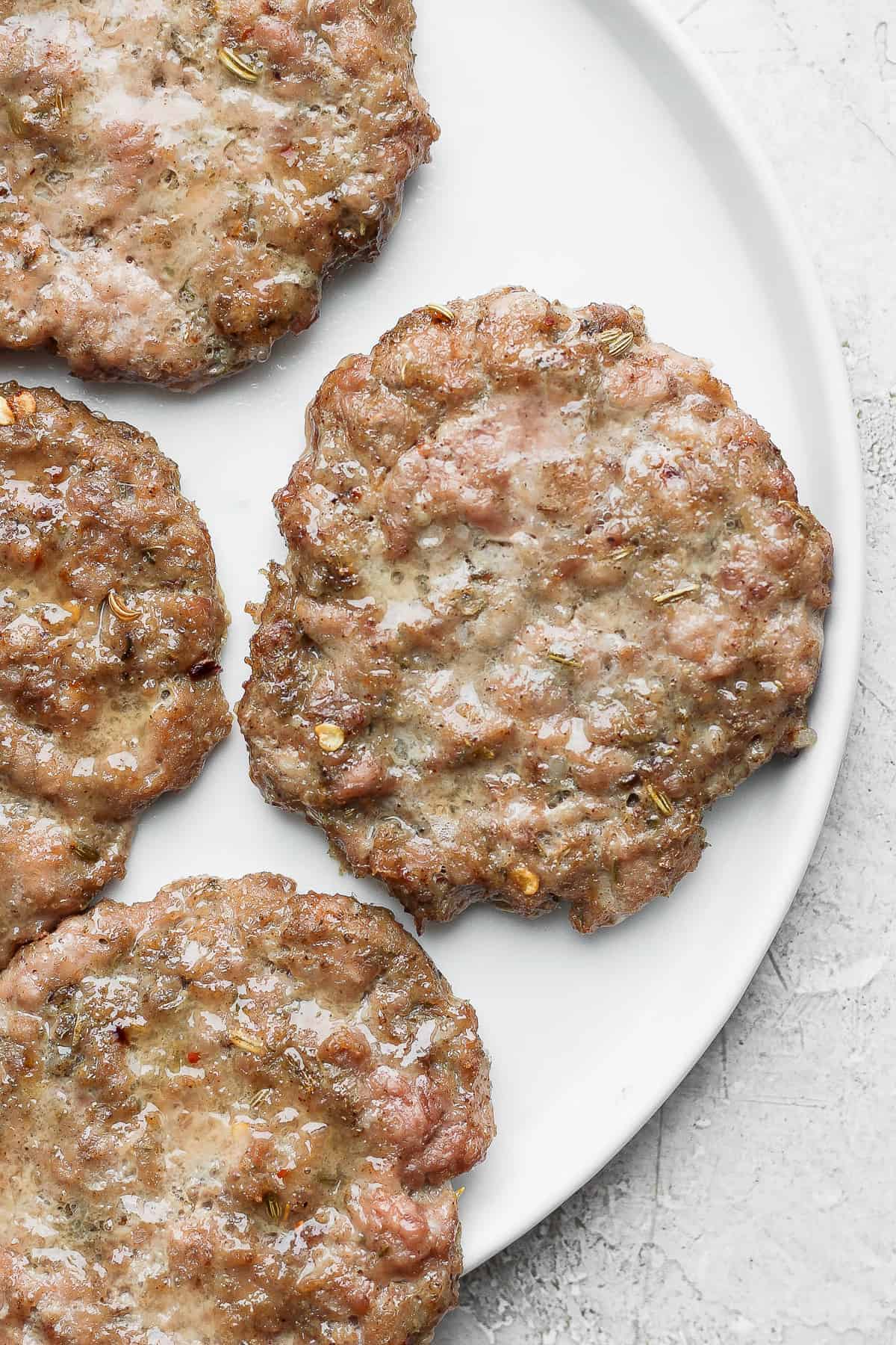Make your own breakfast sausage with this finger-lickin' good Maple Breakfast Sausage recipe. Ours is made with ground pork and turkey, an easy breakfast sausage seasoning, and of course, maple syrup. breakfast sausage on plate