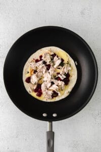 A Thanksgiving leftover quesadilla with turkey and cranberries.