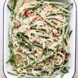A dish with green beans and bacon in it.
