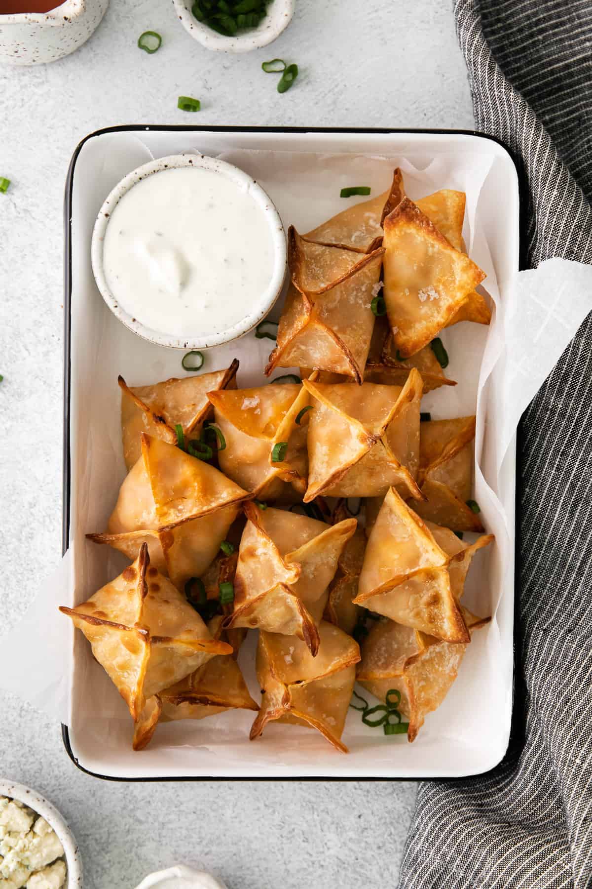These Buffalo Chicken Wontons come together quickly and easily and are made without deep frying thanks to your air fryer! wontons in container