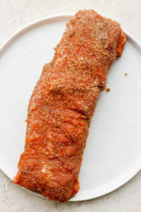 An air-fried pork tenderloin served on a white plate.
