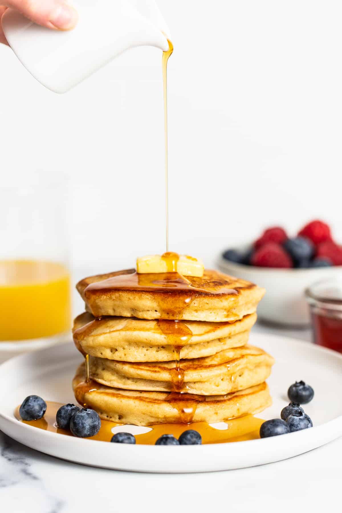 Hoping to find a go-to fluffy pancake recipe that comes out perfect every time! You will love these brown butter fluffy pancakes made with simple ingredients. stack of pancakes