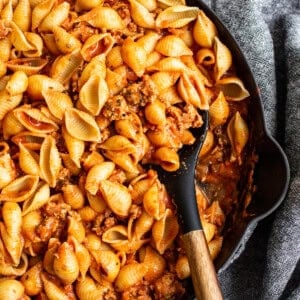 A skillet filled with pasta and meat sauce.
