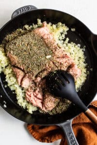 A cast iron skillet filled with herbs and spices.