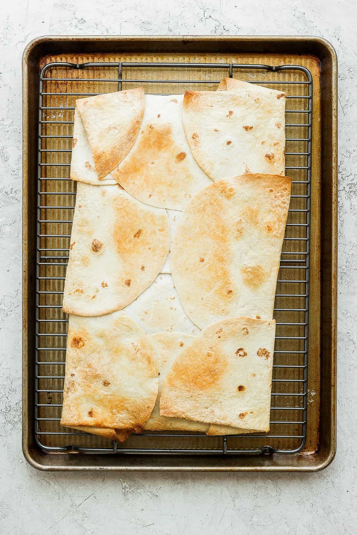 Golden brown quesadillas on a baking sheet. 