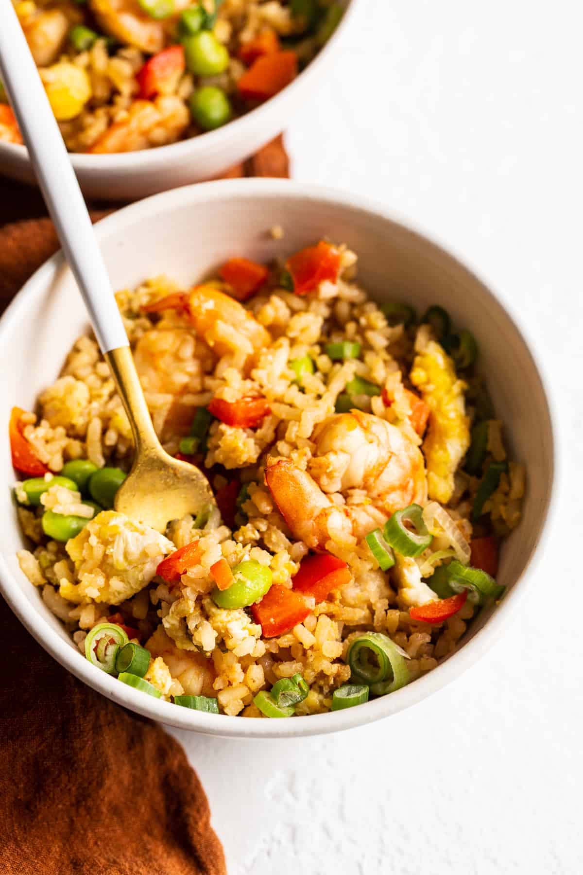 Got leftover white rice? Make shrimp fried rice for a protein and veggie-packed meal ready to go in less than 30 minutes. shrimp fried rice in bowl