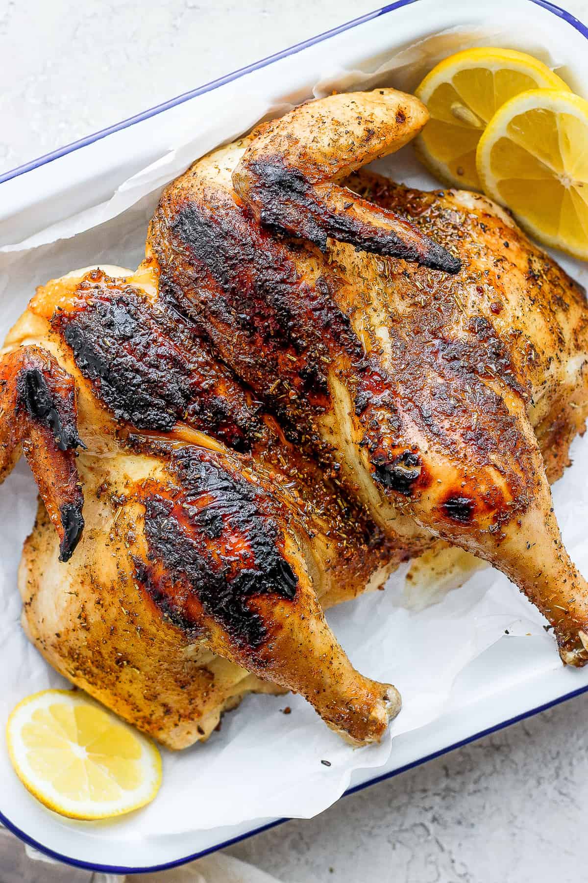 cooked whole chicken on platter.