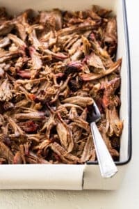 Shredded smoked pork shoulder in a tray.