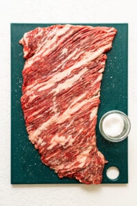 A piece of beef on a cutting board.