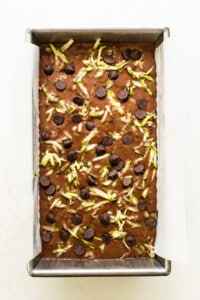 A baking pan filled with chocolate chips and green chile.