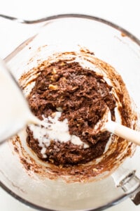 Chocolate cookie batter being mixed in a bowl.