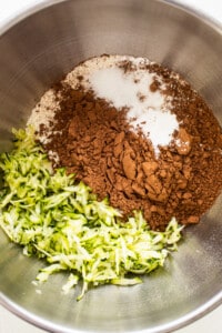 A bowl of ingredients with zucchini and chocolate in it.