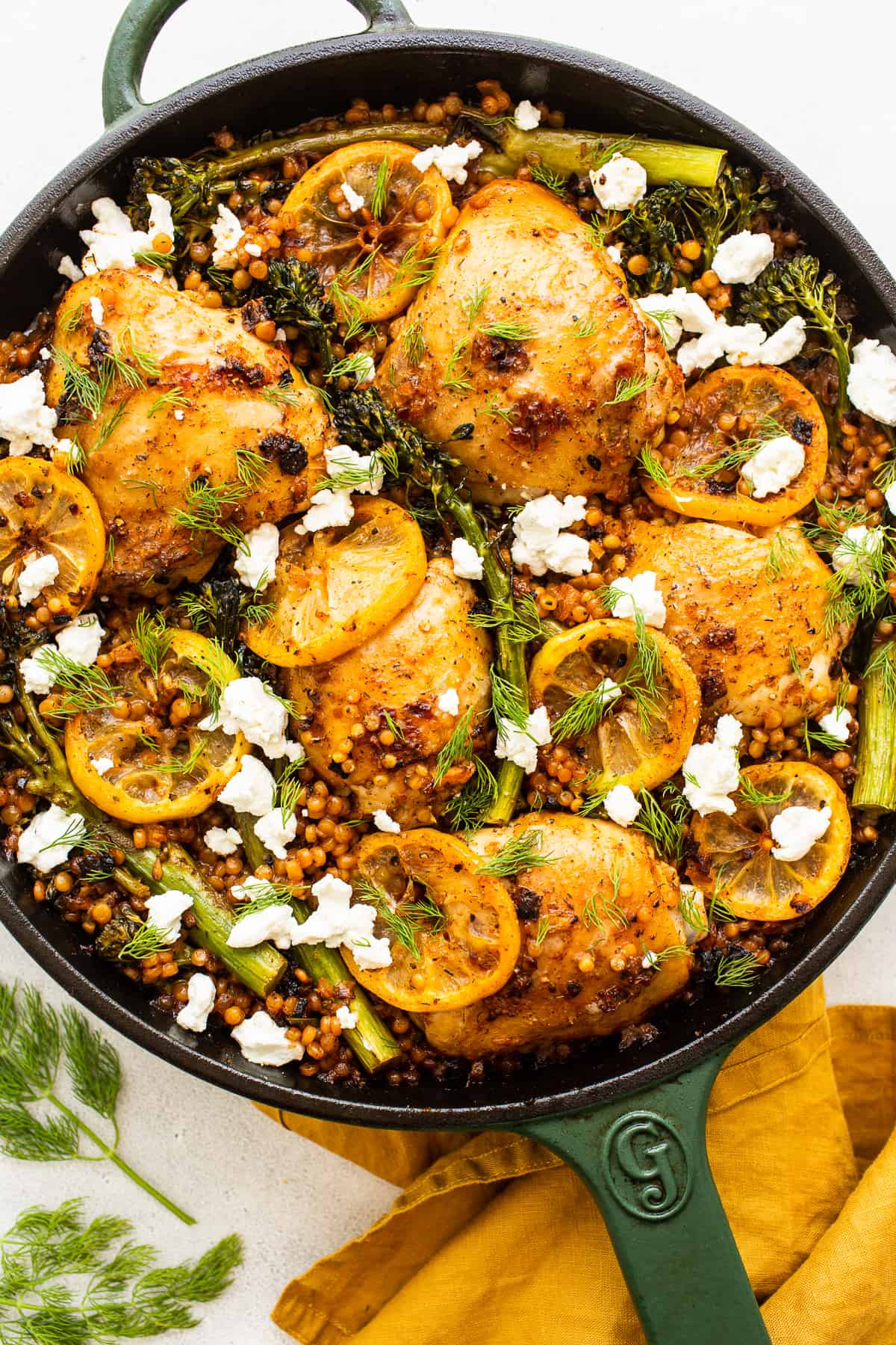 This Lemon Chicken Skillet is seasoned with delicious spices, seared and then cooked with couscous and broccolini for a flavorful one-pot meal. Lemon chicken skillet topped with goat cheese.