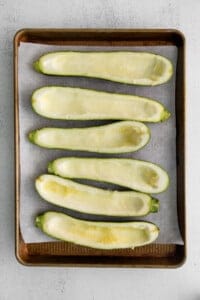 Sliced zucchini on a baking sheet.