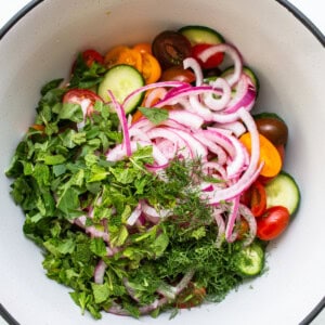 Add fresh mint and onions to tomatoes.