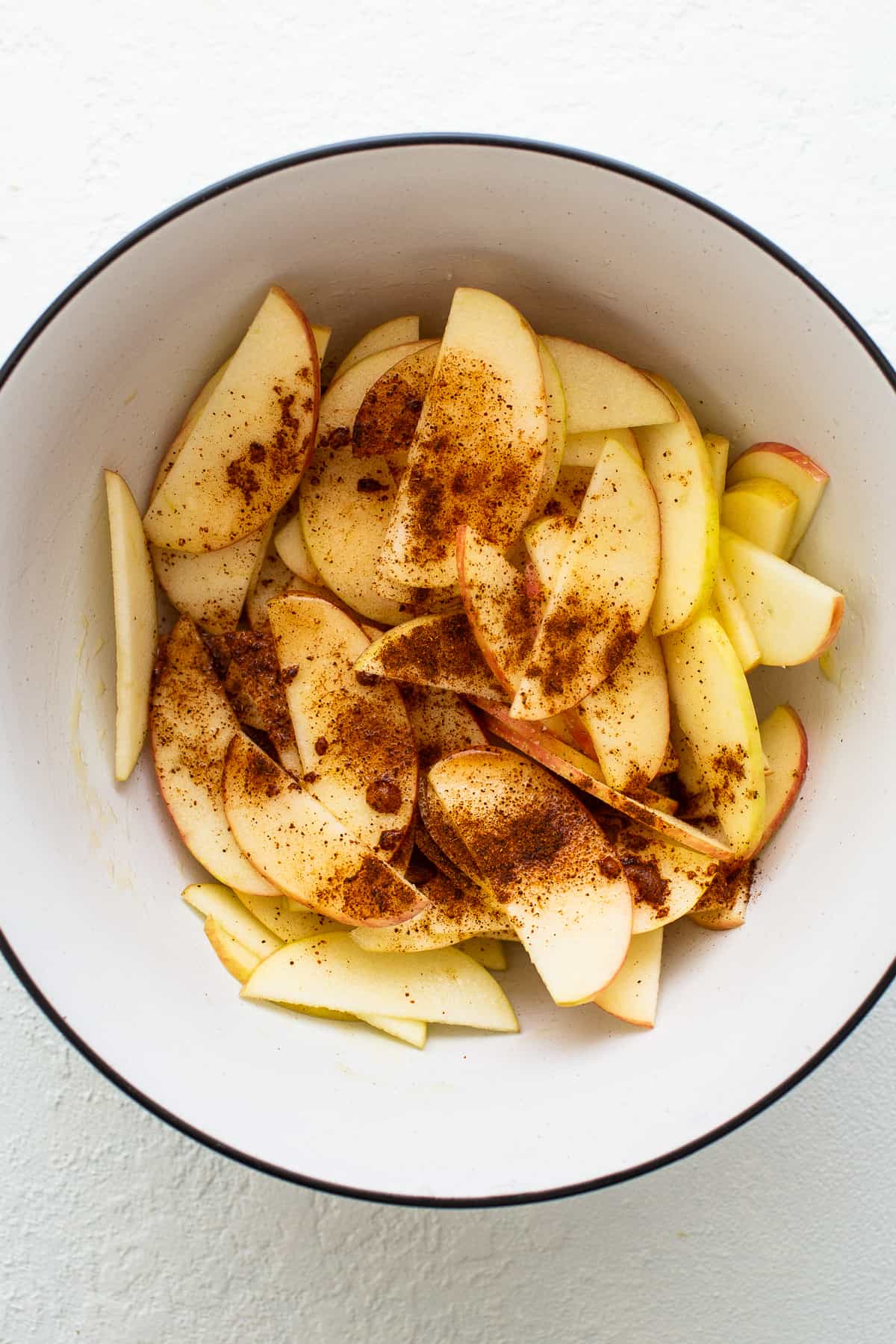 Apples and spices in a bowl.