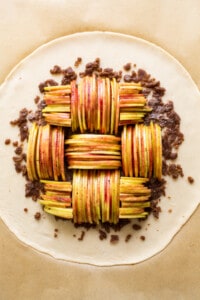 A pie with apples on top of a sheet of paper.