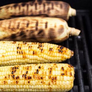grilling corn on grill.