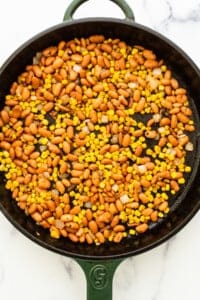A skillet filled with beans and corn.