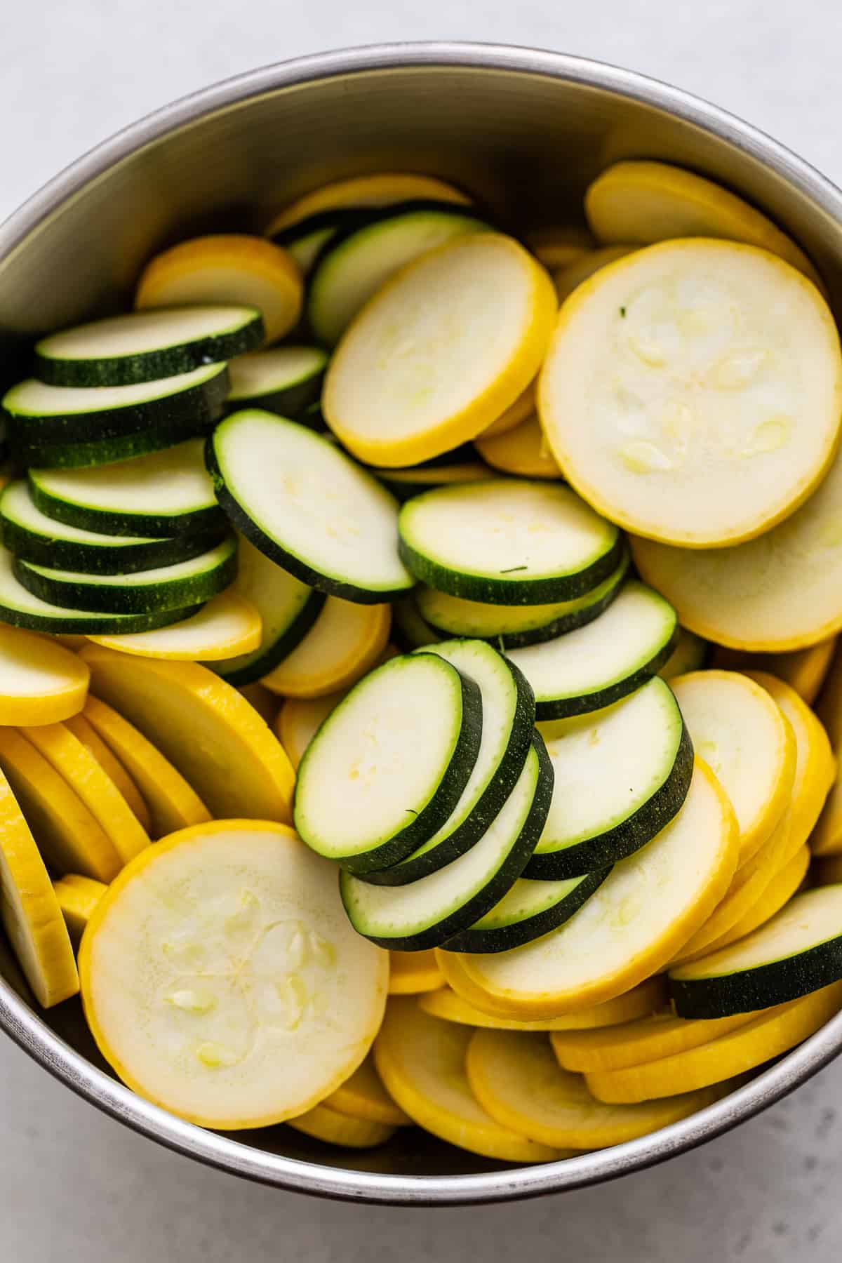 Sliced squash and zucchini in a bowl. 