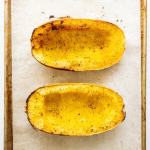 sliced spaghetti squash on baking sheet.