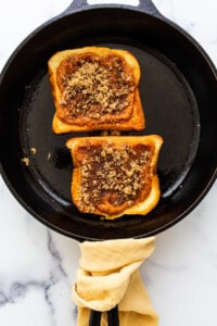 Two slices of french toast in a skillet.