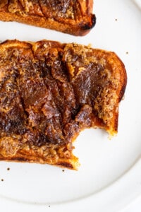 Two slices of bread with caramel on top.