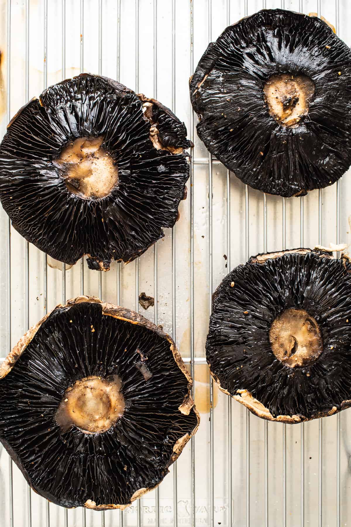 Portobello mushrooms on a baking sheet.