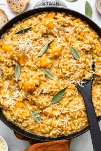 Squash risotto in a skillet with sage.