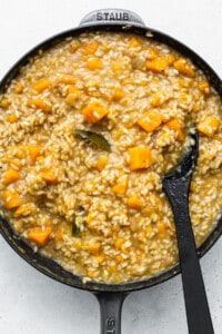 A skillet filled with risotto and squash.