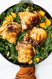 Chicken and veggies in a skillet.