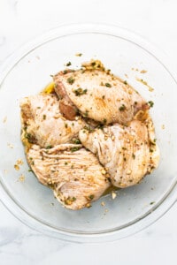 Chicken thighs in a bowl.