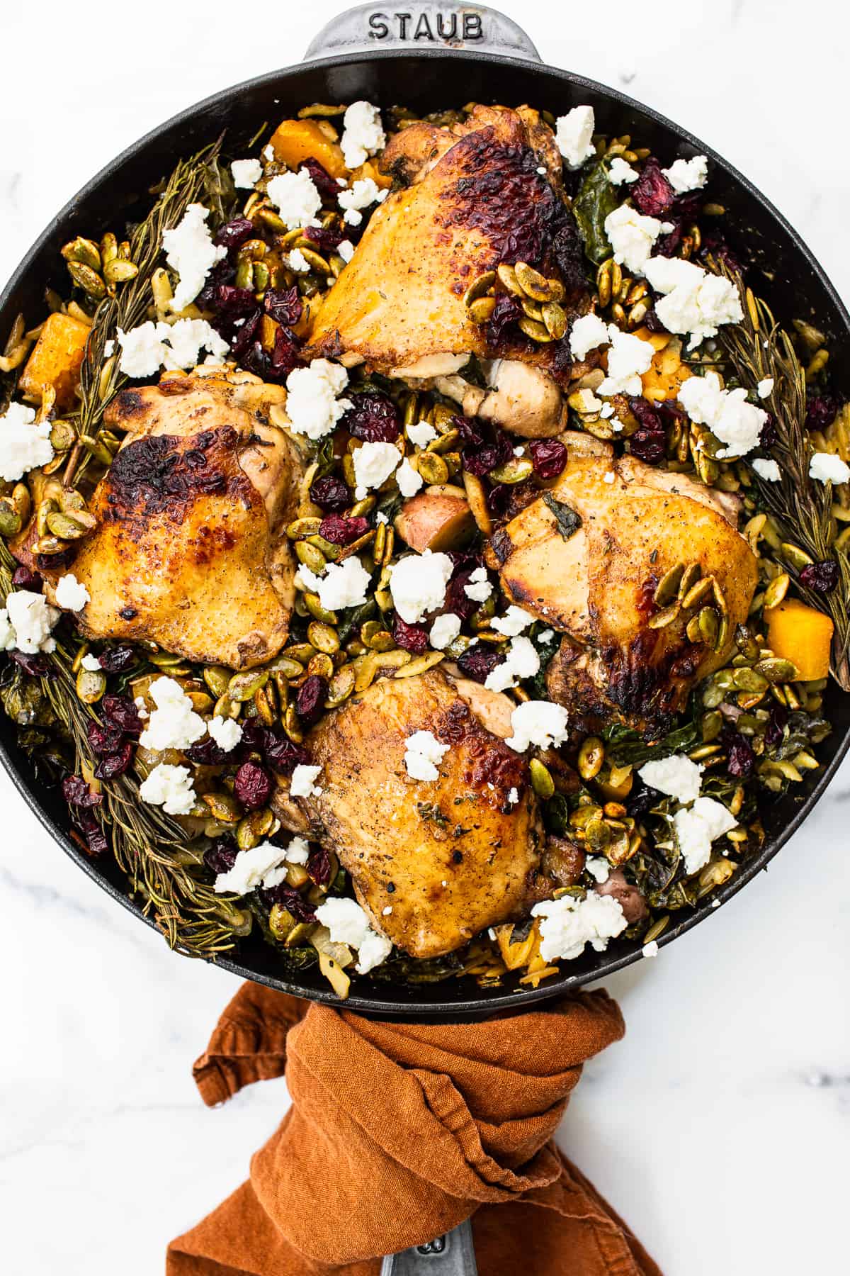 Harvest orzo chicken skillet topped with goat cheese.
