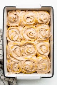 Pumpkin cinnamon rolls in a baking dish.