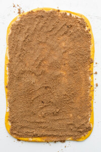 A square of sand on a white surface.