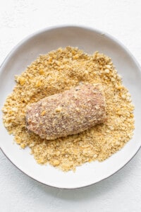 dipping pork chops in breadcrums
