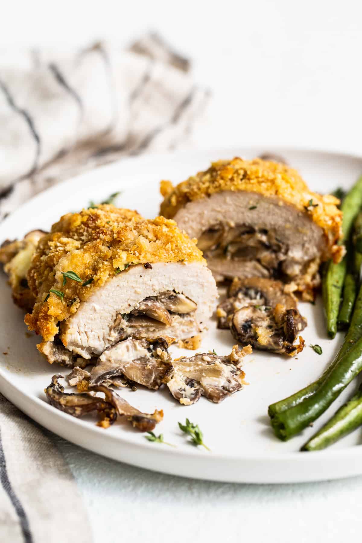 These stuffed pork chops are crunchy on the outside and packed with cheesy mushroom goodness on the inside making these the ultimate weeknight meal. mushroom stuffed pork chops.