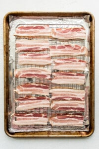 Bacon strips on a baking sheet.