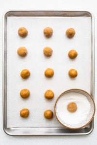 A tray of peanut butter balls on a white surface.