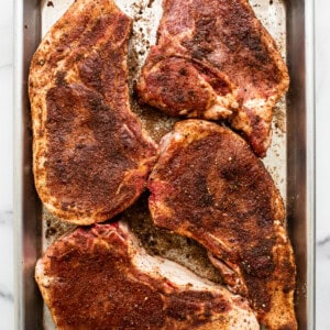 Roasted pork chops on a baking sheet.