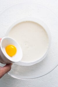 Adding an egg to the melted ice cream.