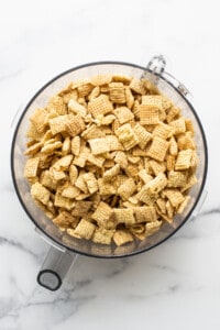 Chex cereal in a bowl on a marble countertop.