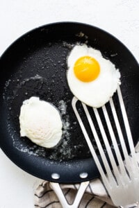 Two fried eggs in a frying pan.