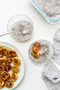 Chia seeds on a plate next to a bowl of chia seeds.